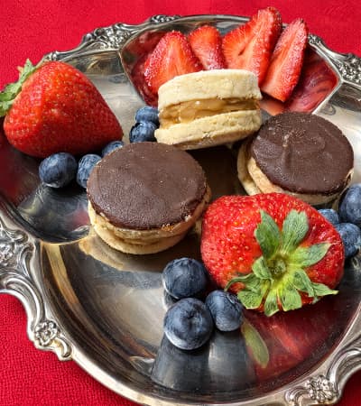 Alfajores and strawberries served on a silver plate