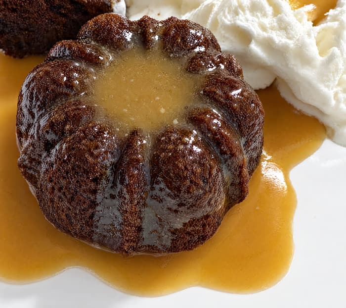 Sticky toffee pudding cake with whipped cream and toffee sauce